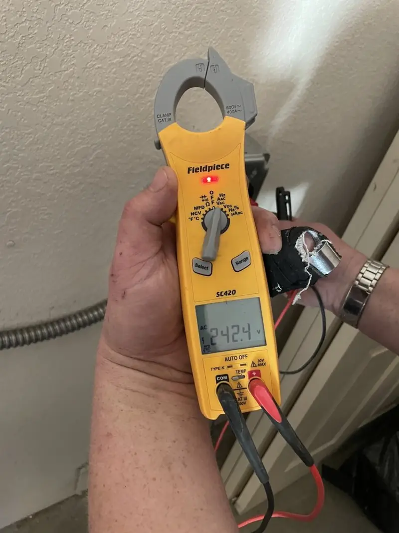 Voltage testing with clamp meter during Ceiling Fan Installation in Windham